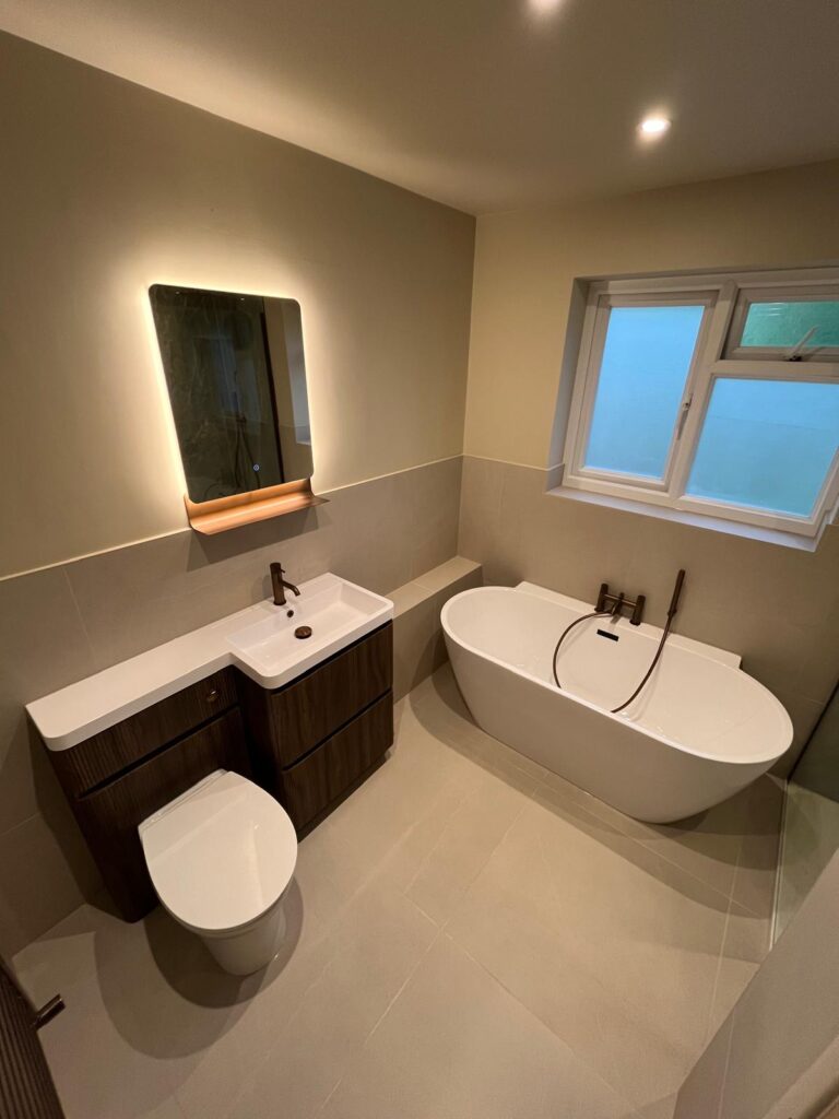 Overview of bathroom refurbishment with toilet, sink and bath.